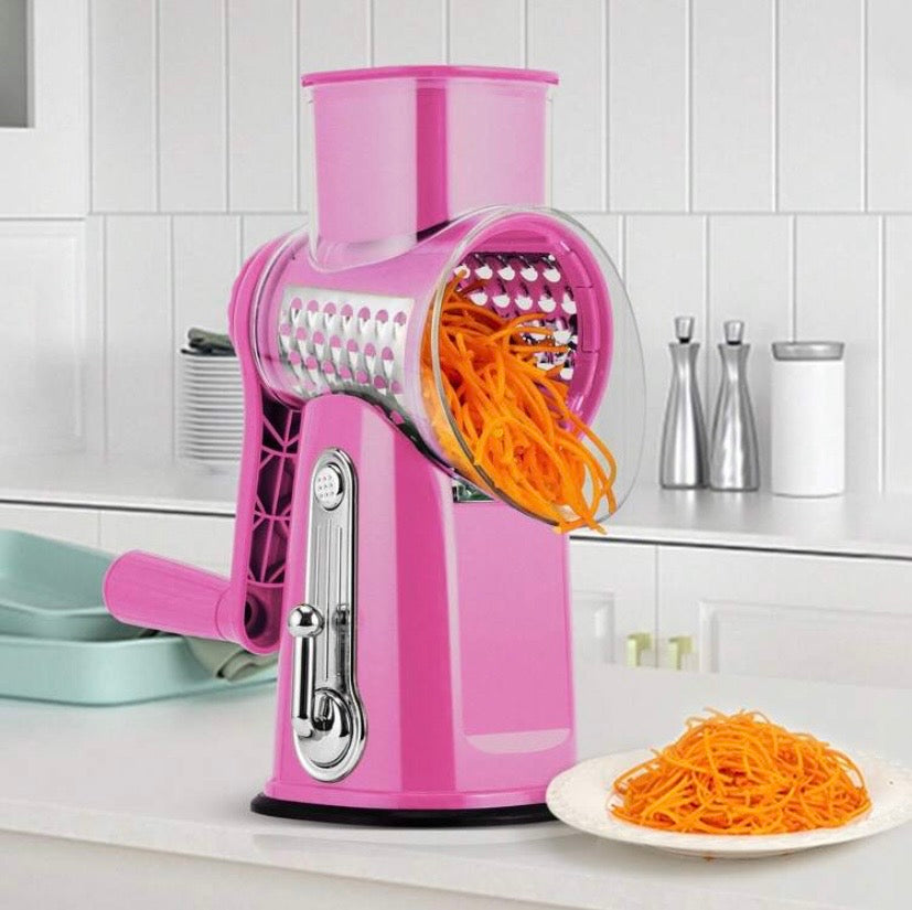 Râpe rotative manuelle avec poignée et lames interchangeables, base ventouse et rangement intégré, idéale pour fromage, légumes et fruits secs.
