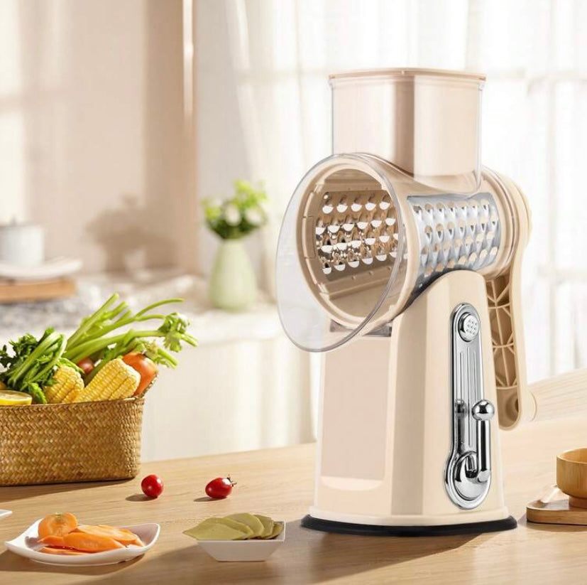 Râpe rotative manuelle avec poignée et lames interchangeables, base ventouse et rangement intégré, idéale pour fromage, légumes et fruits secs.