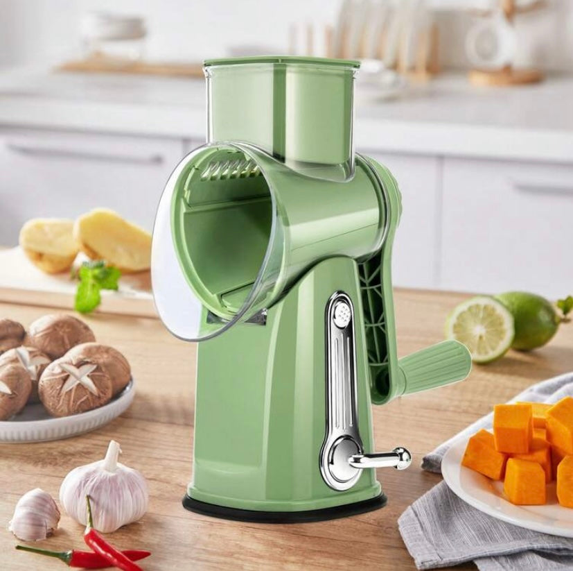 Râpe rotative manuelle avec poignée et lames interchangeables, base ventouse et rangement intégré, idéale pour fromage, légumes et fruits secs.